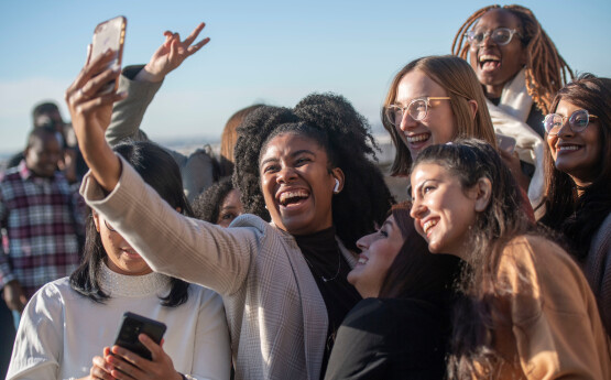 Group of smiling women taking a selfie at the beach 