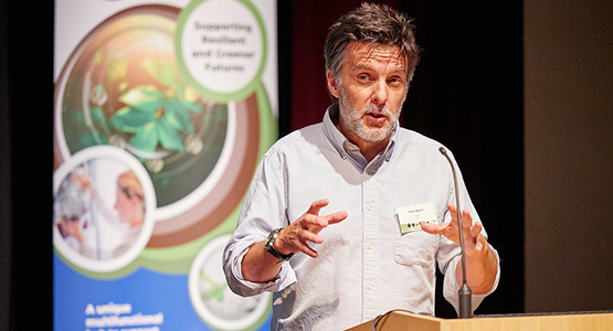 academic presenting at a conference