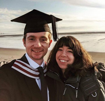 Becky and Joe on the beach at graduation
